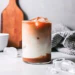 Glass of iced caramel macchiato with straw