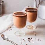 two dessert cups filled with coffee panna cotta with espresso syrup.