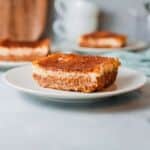 baked coffee cheesecake slice on white plate.