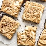 espresso swirl cheesecake bars on paper top view.