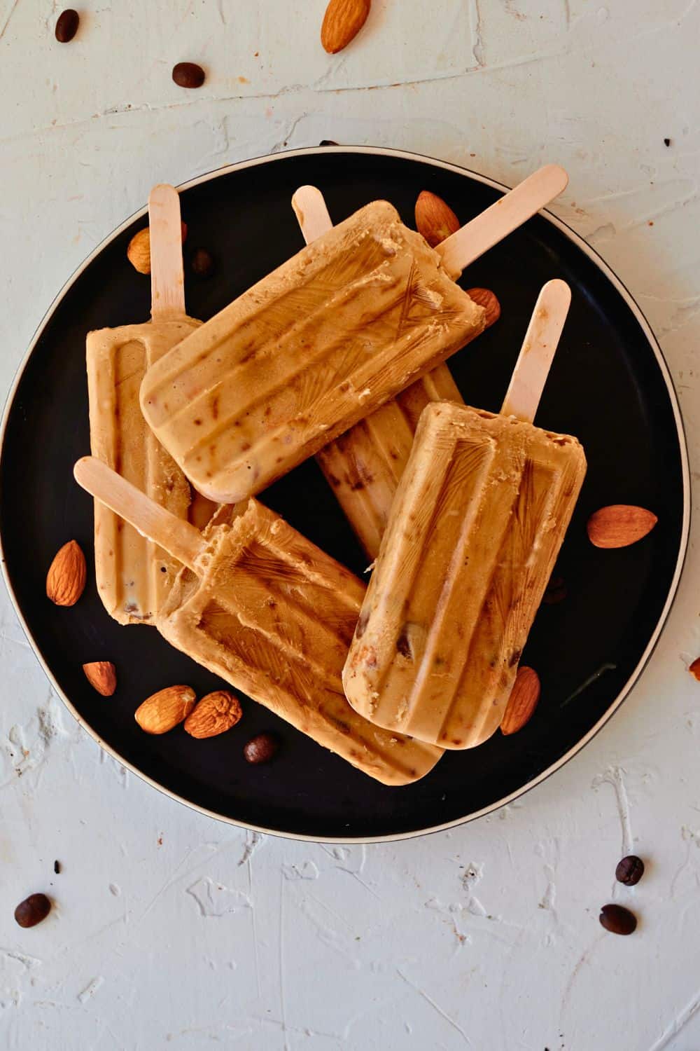 mocha popsicles on black plate.