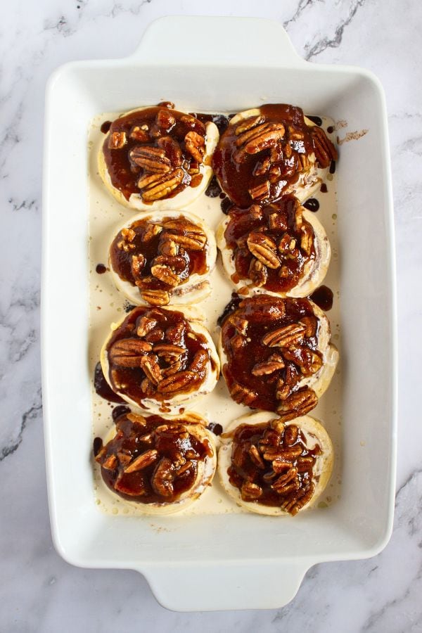 pecan sugar topped cinnamon rolls in dish.
