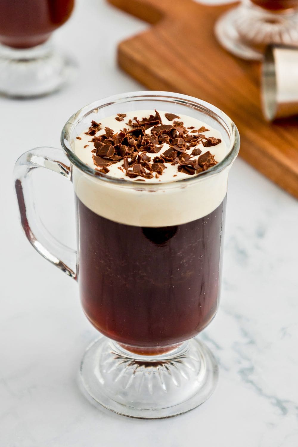 irish coffee with chocolate shavings in glass mug.
