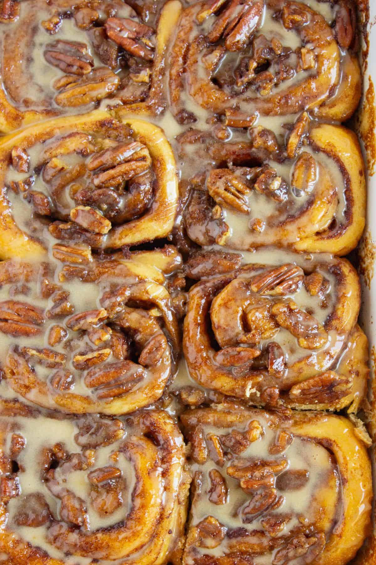 canned cinnamon rolls with heavy cream in baking dish closeup.