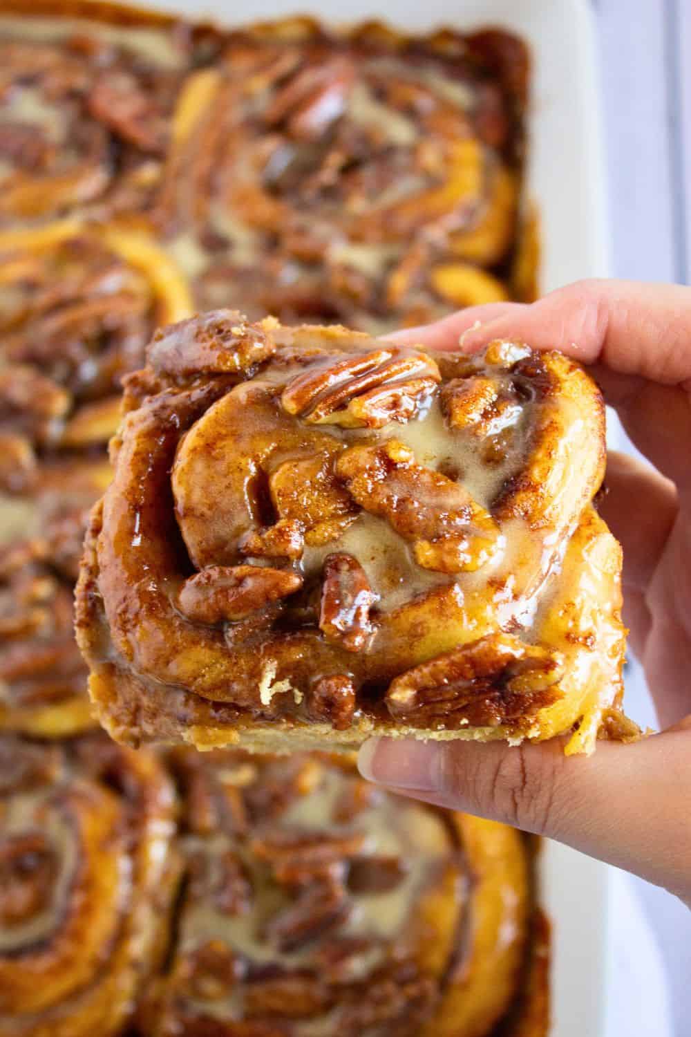semi homemade cinnamon roll above baking dish.