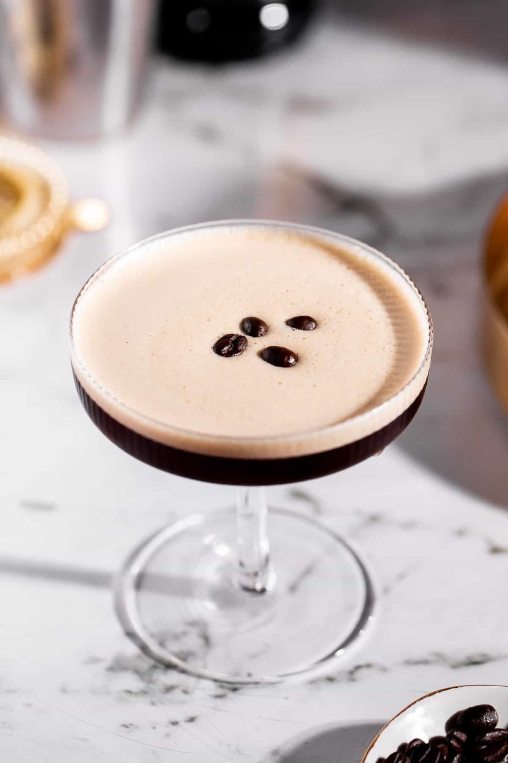 tequila espresso martini with coffee beans in glass.