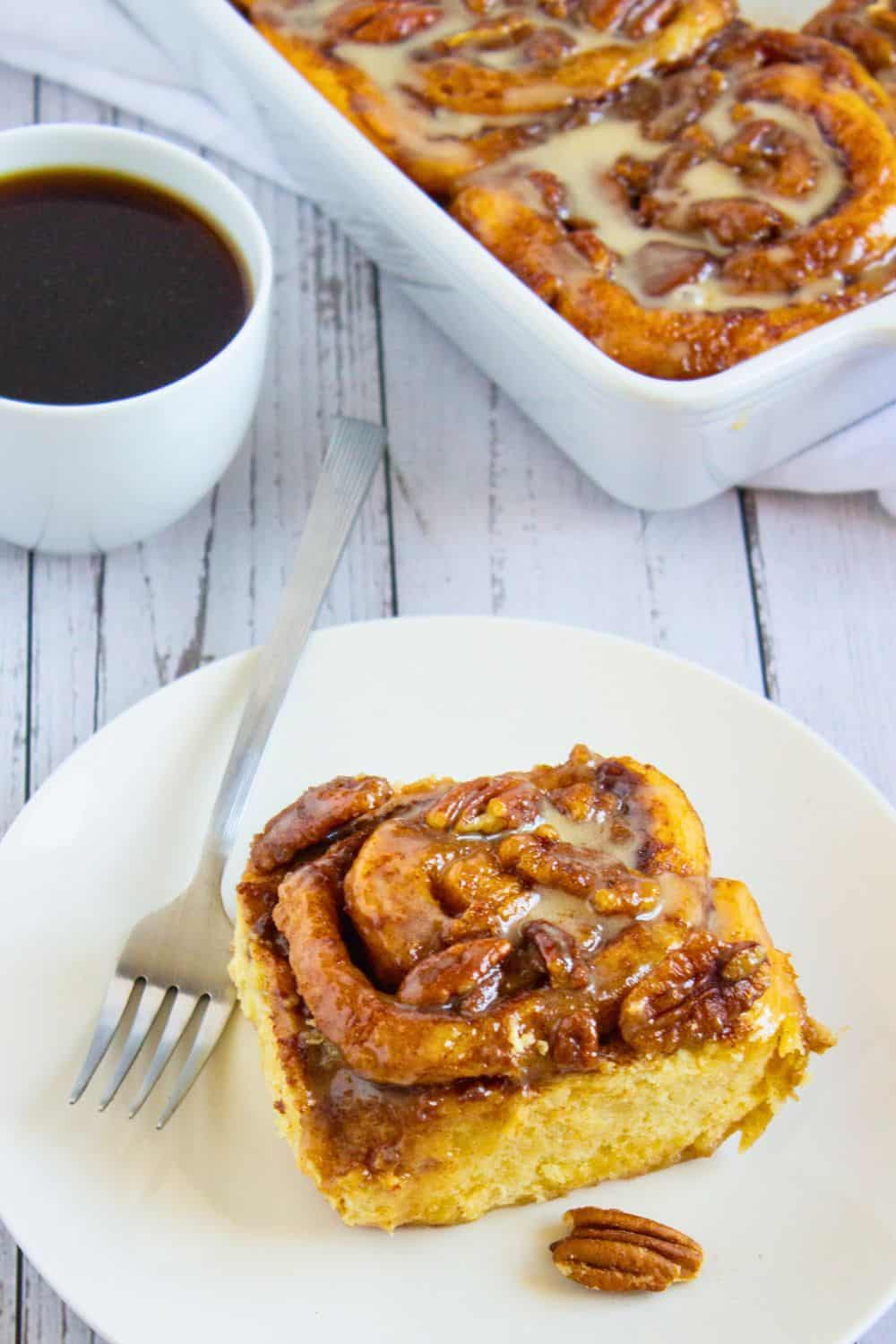 viral tiktok cinnamon roll with heavy cream on plate.
