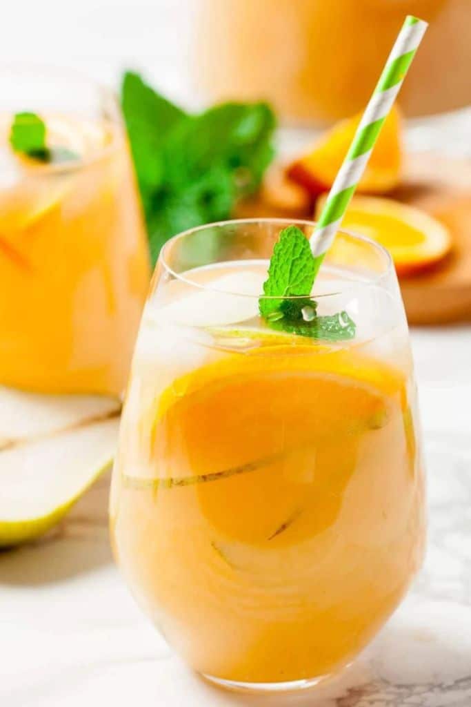 pear sangria in glass with straw.