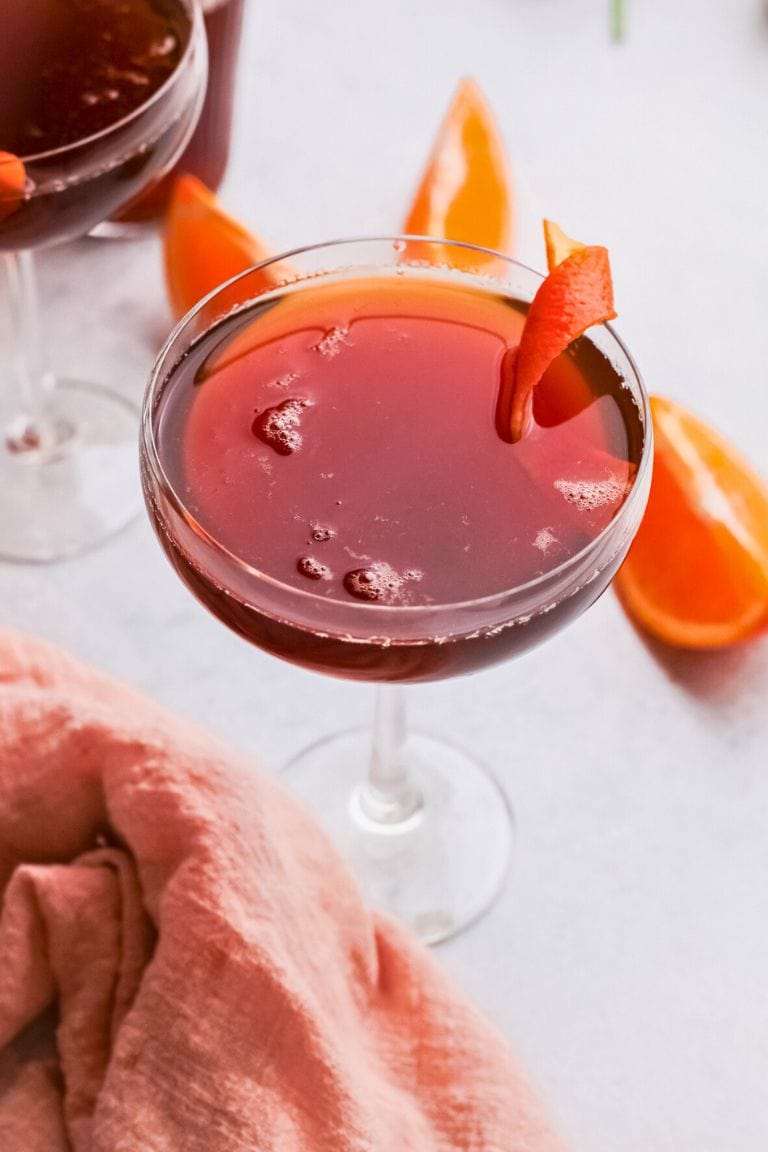 italian siciliano cocktail with orange garnish.