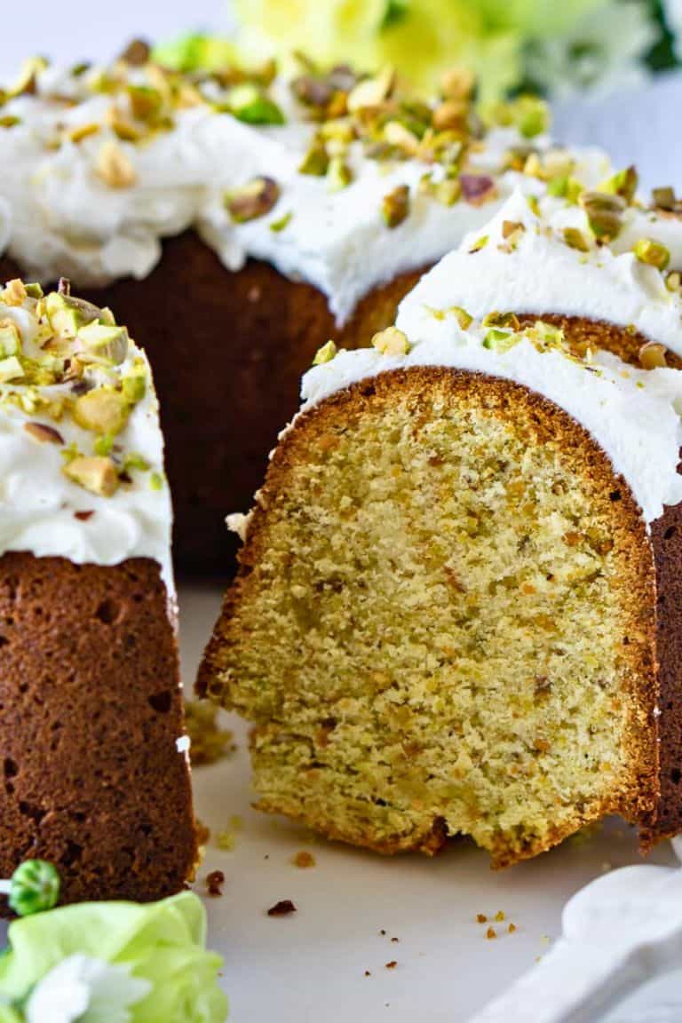iced lemon pistachio bundt cake sliced.