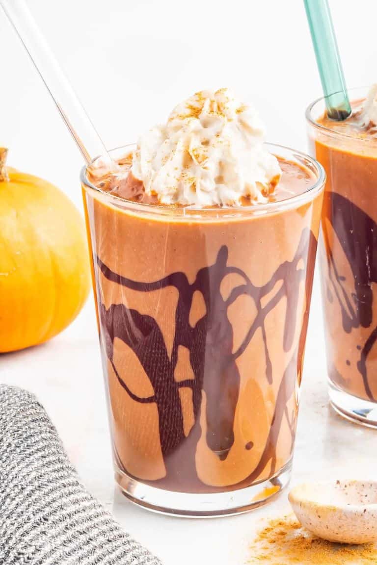 chocolate pumpkin shake in tall glass with straw.