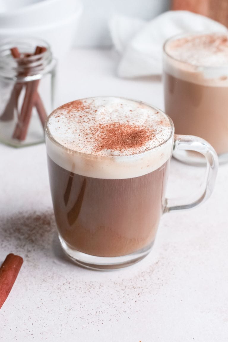 hot cinnamon latte in glass mug.