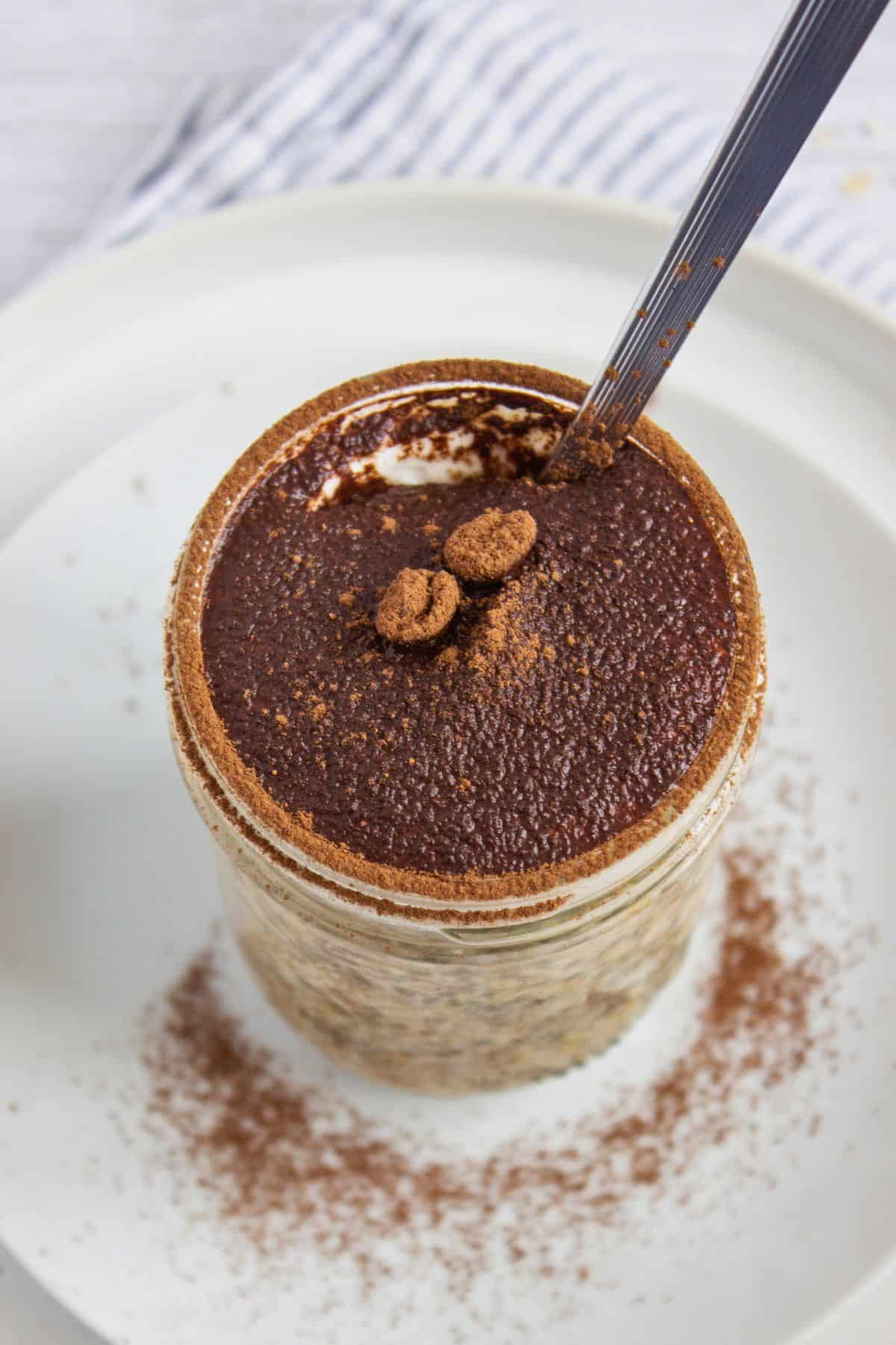 overnight oats with coffee flavor in jar with spoon.
