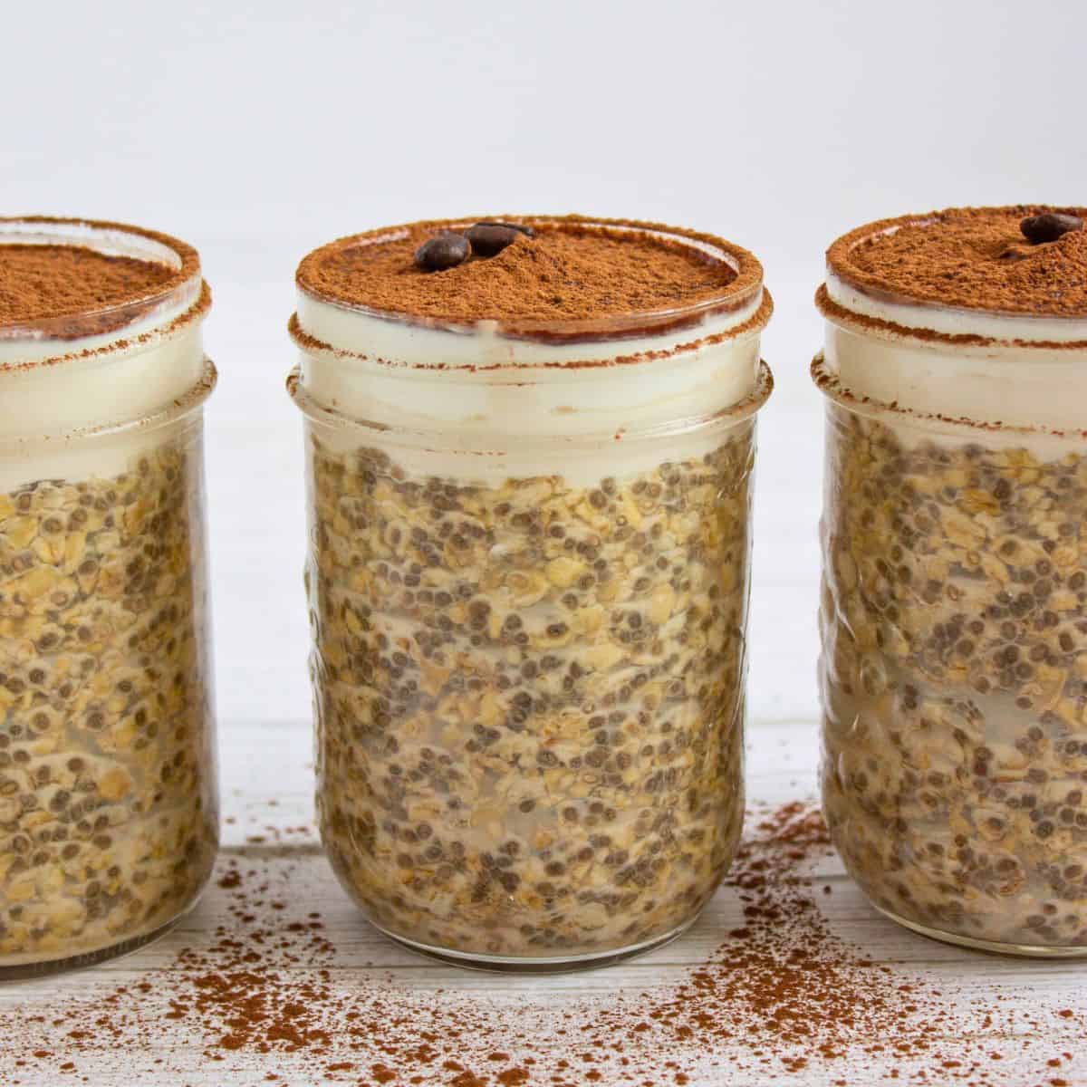 healthy tiramisu overnight oats in jars lined up.