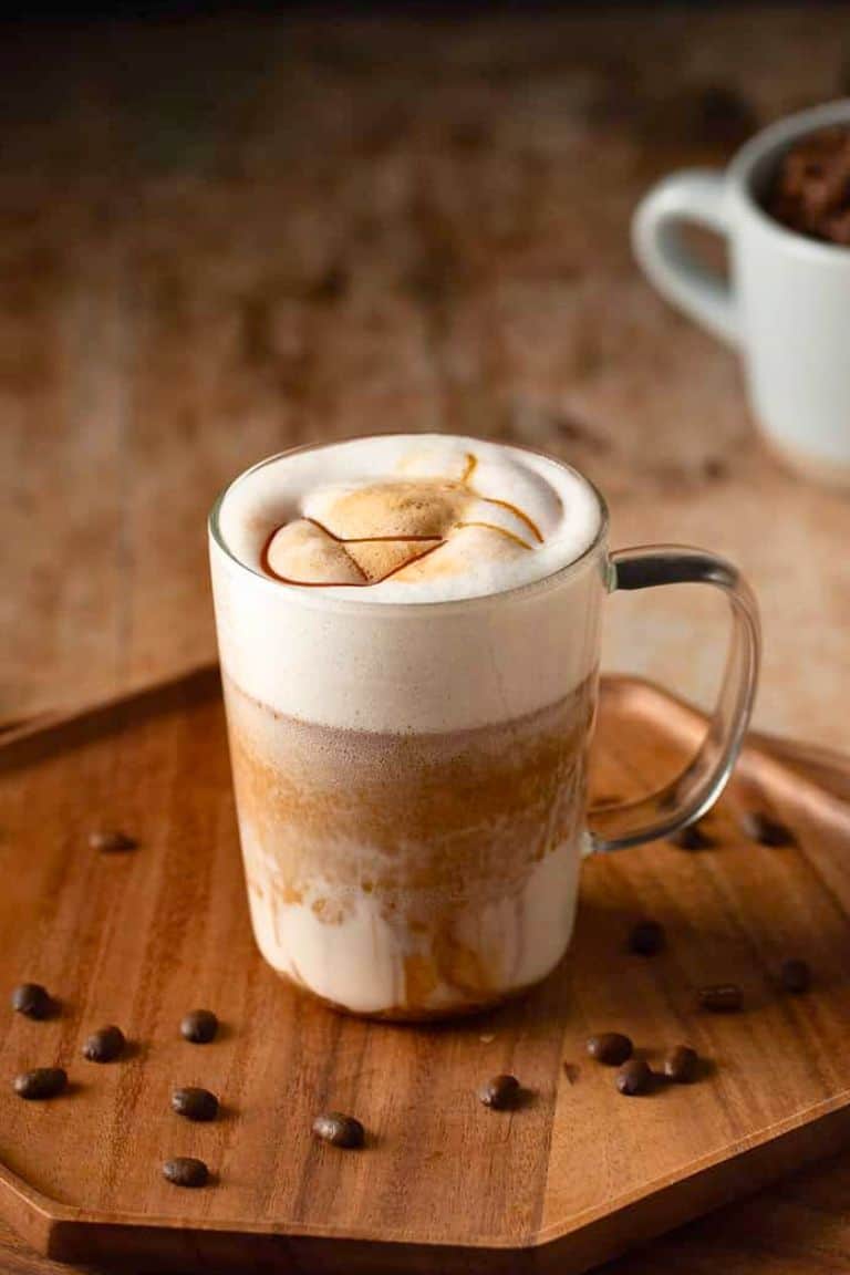 hot caramel macchiato in glass mug.