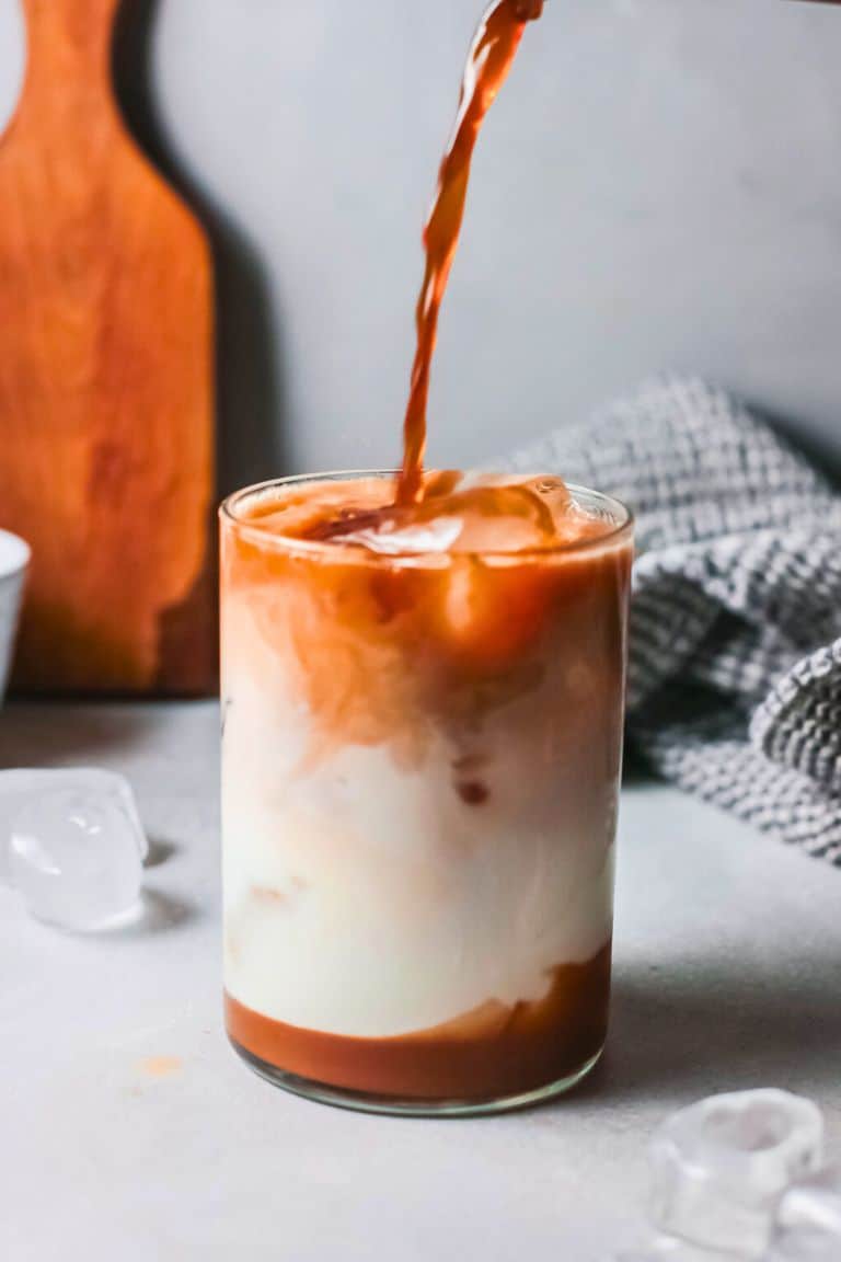 pouring coffee into caramel macchiato.