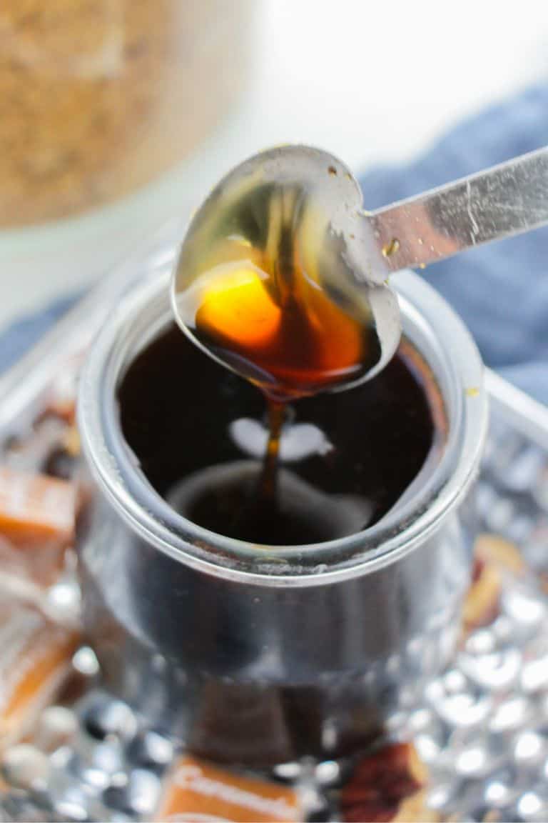 pecan flavored coffee syrup in glass jar with spoon.