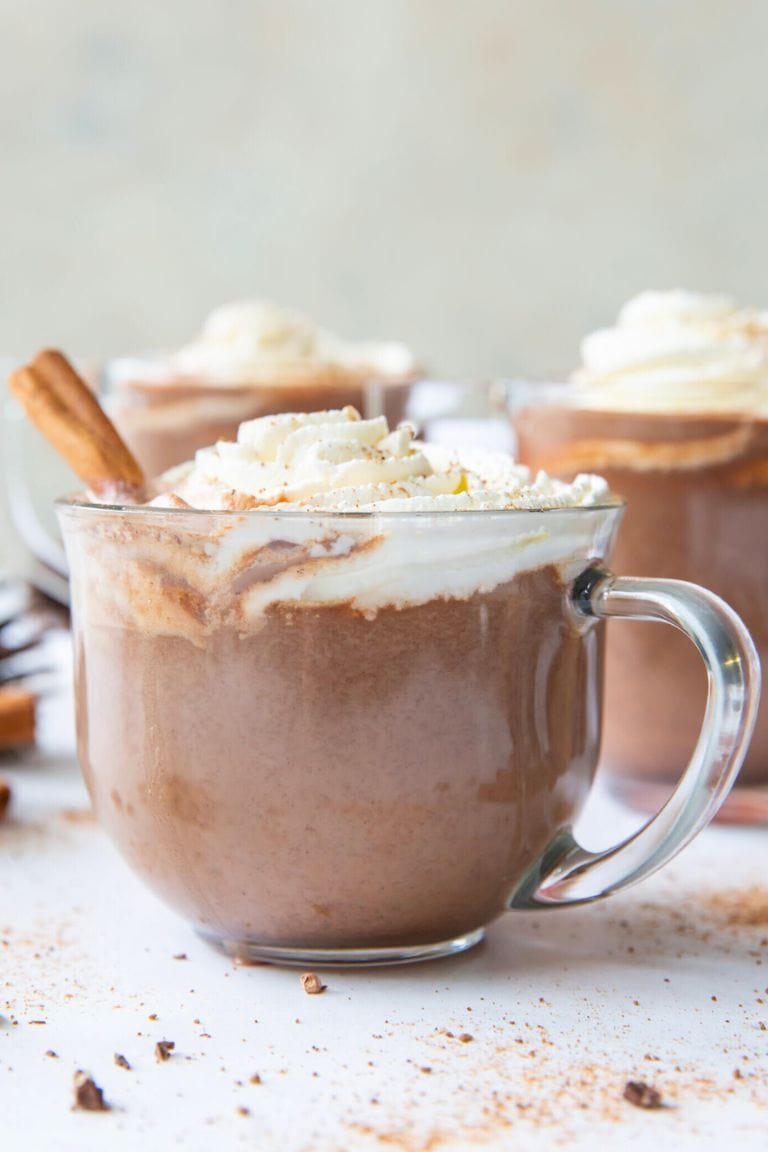pumpkin hot chocolate topped with whipped cream in mug.