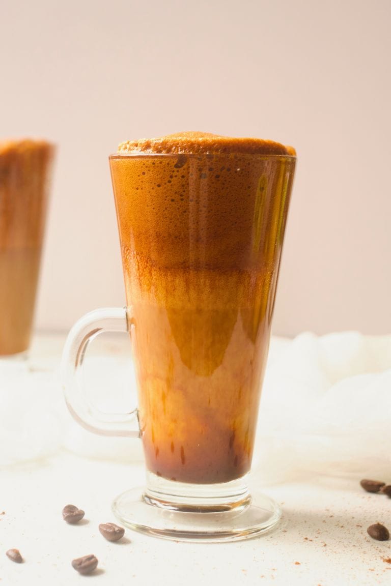 dalgona eggnog coffee in tall glass mug.