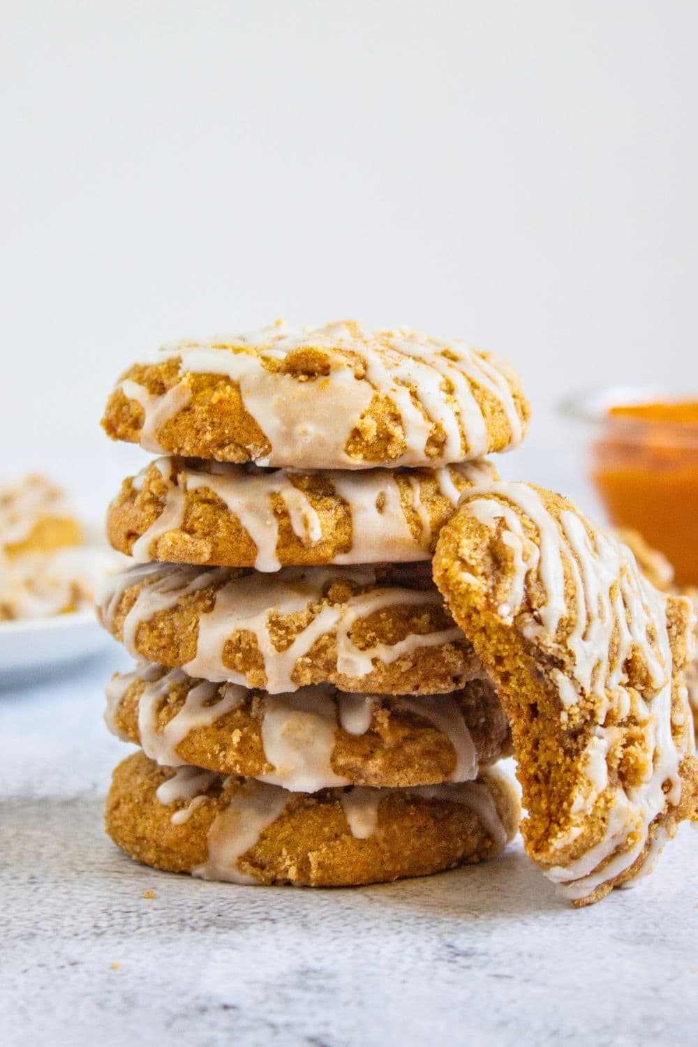 glazed pumpkin crumble cookies in a stack.