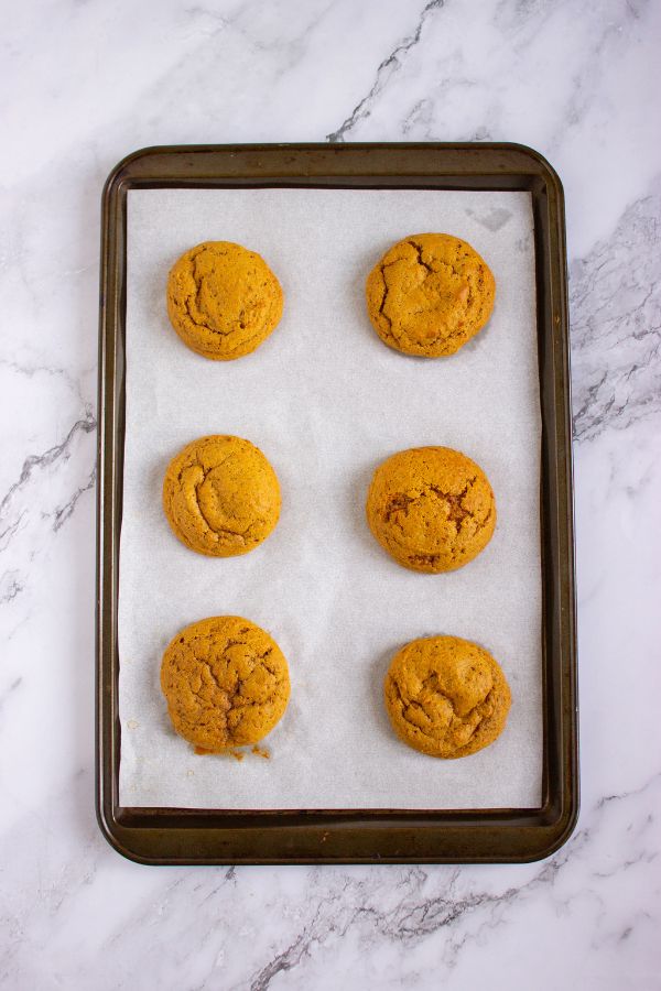 freshly baked pumpkin cookies on tray.