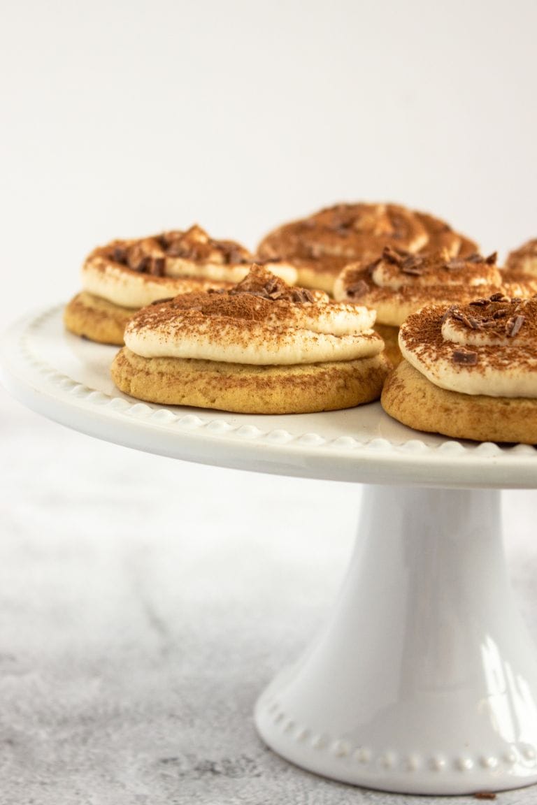 tiramisu cookies on white cake stand.