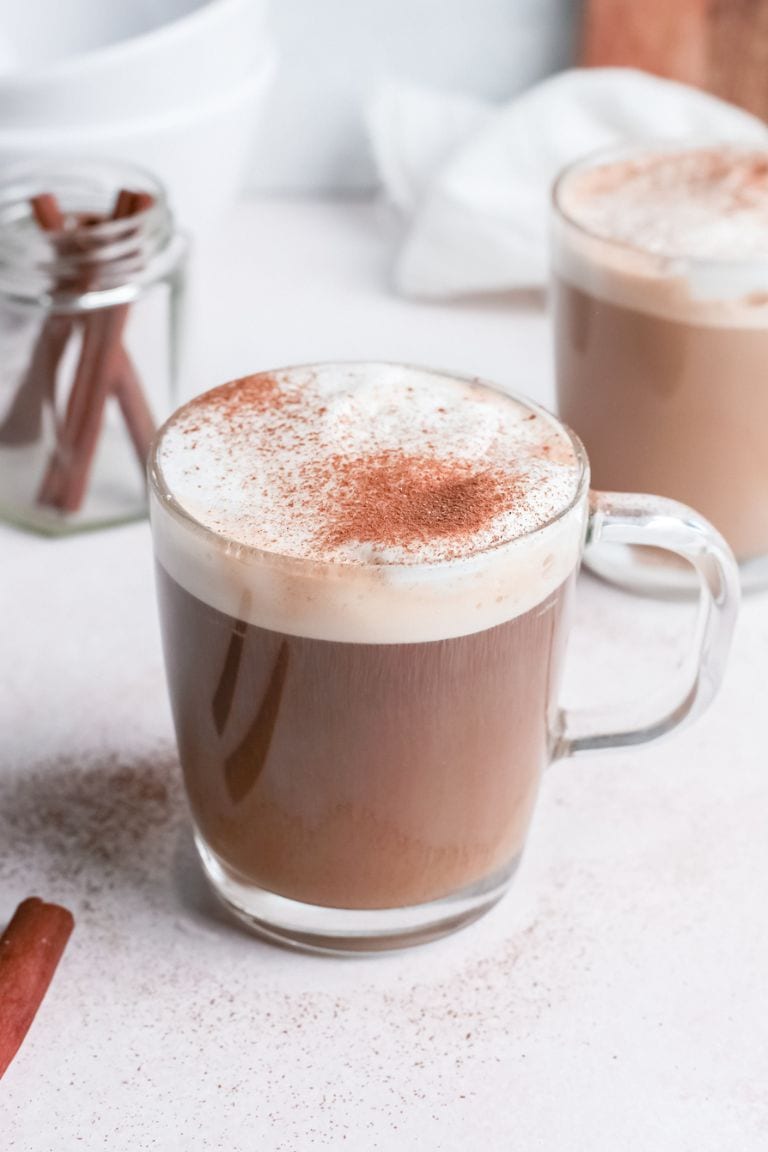 Creamy cinnamon latte topped with cinnamon.
