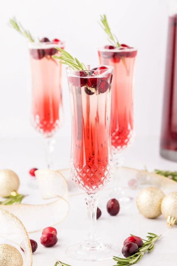 cranberry mimosas in champagne glasses.