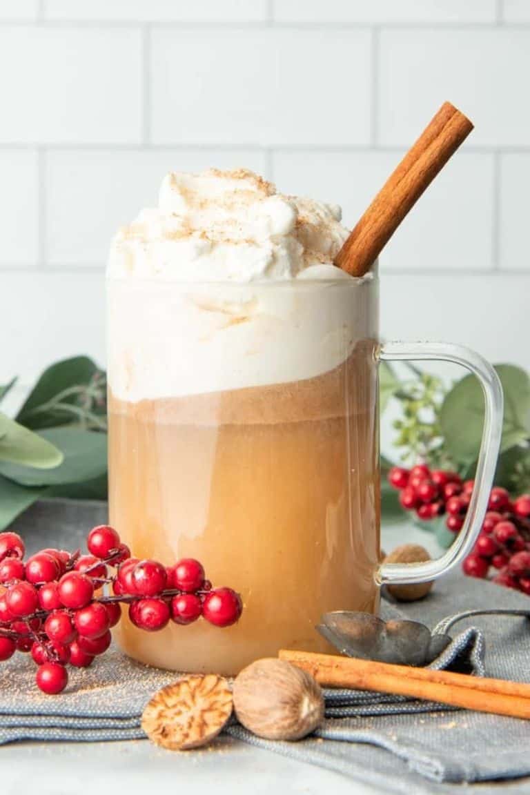 hot buttered rum holiday cocktail topped with whipped cream.