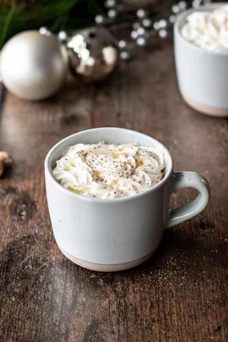 hot eggnog latte topped with whipped cream.
