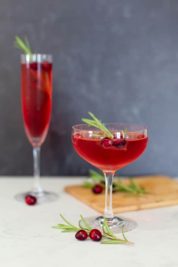 poinsetta champagne cocktail with festive garnish.