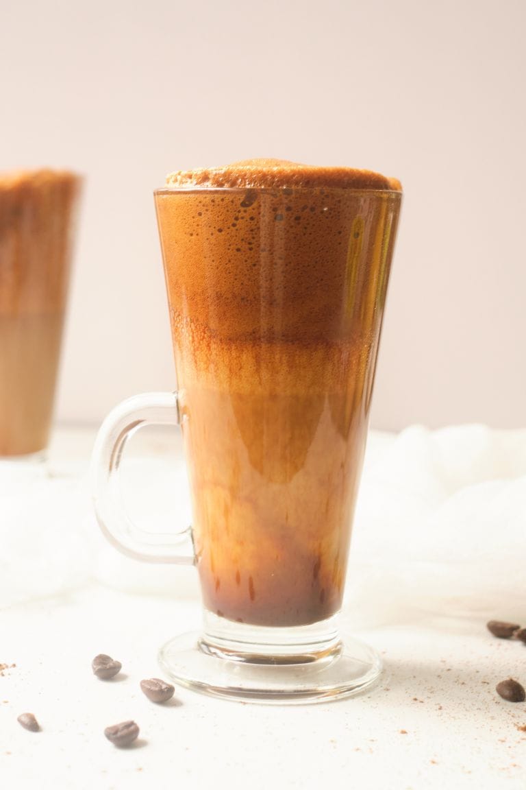 dalgona eggnog coffee in tall glass.
