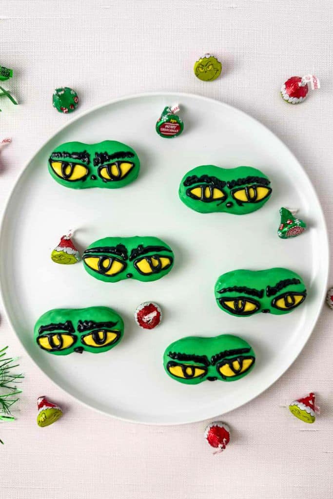 decorated grinch nutter butter cookies on plate.