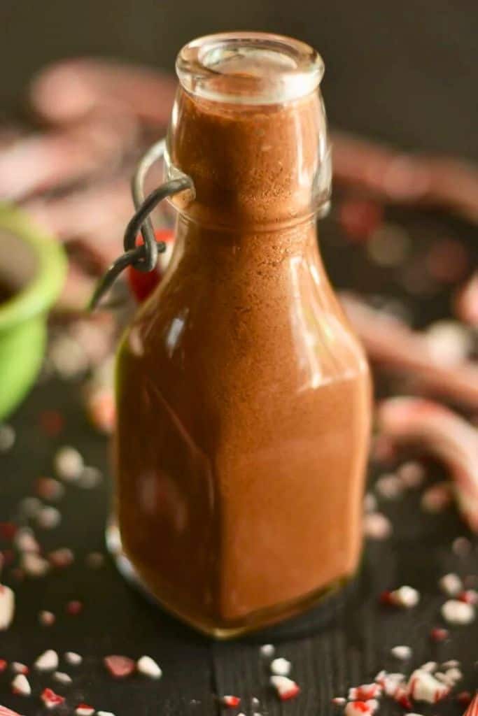 peppermint creamer in jar surrounded by crushed candies.