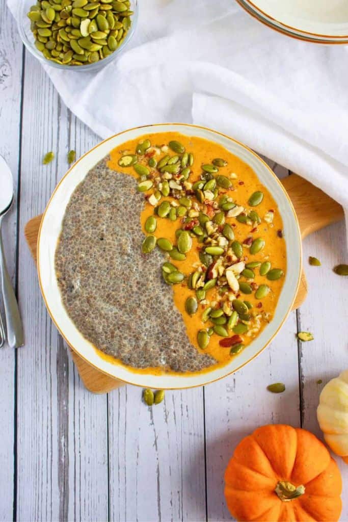 pumpkin chia pudding in a bowl with pumpkin cream.