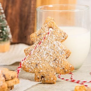 Cut Out Christmas Tree Sugar Cookie with glass of milk.