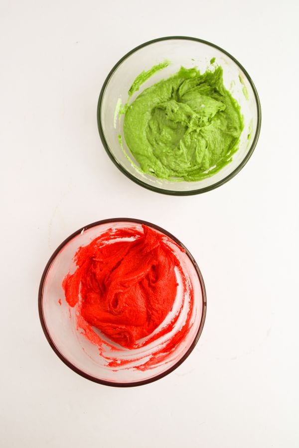 red and green frosting in bowls.