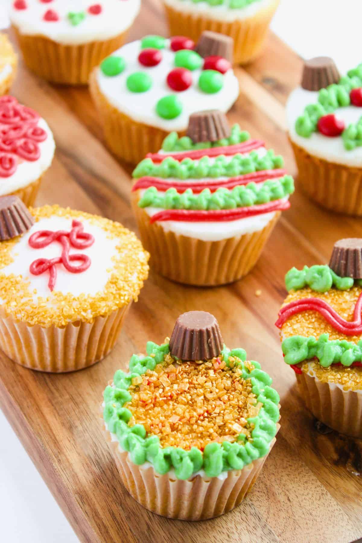 christmas ornament cupcakes on board.
