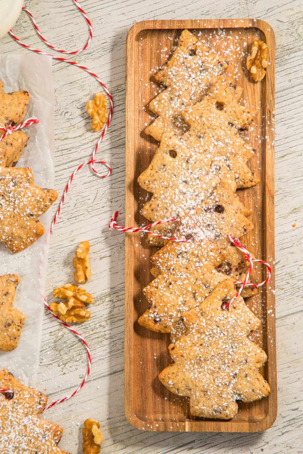 christmas tree shaped cookies on wooden platter.