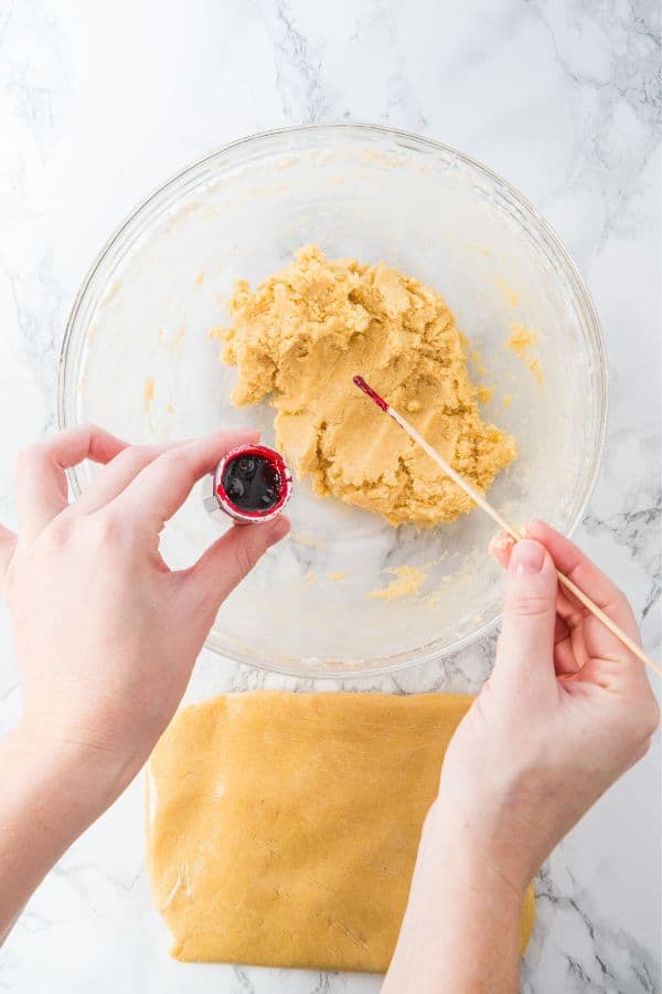 dyeing cookie dough pink with gel food color.