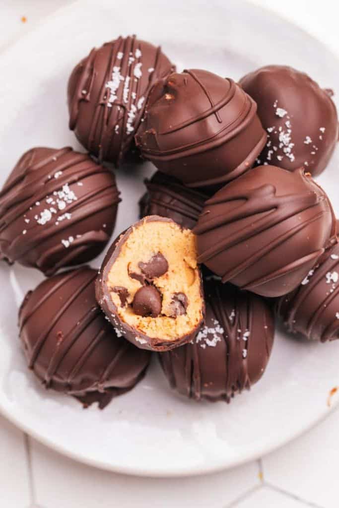 chocolate coated cookie dough bites on plate.