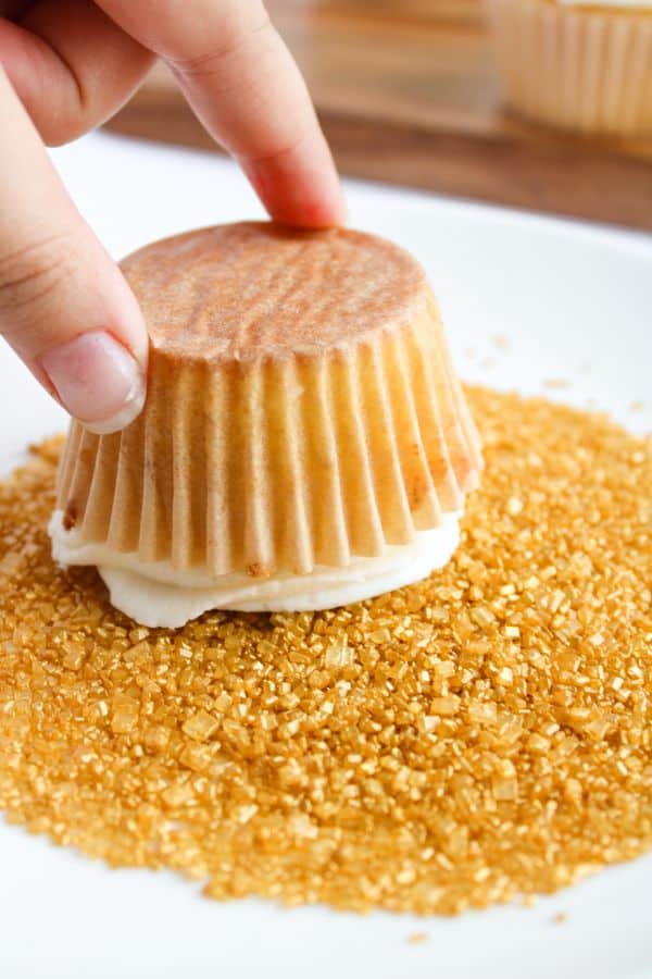gold sanding sugar and frosted cupcake.
