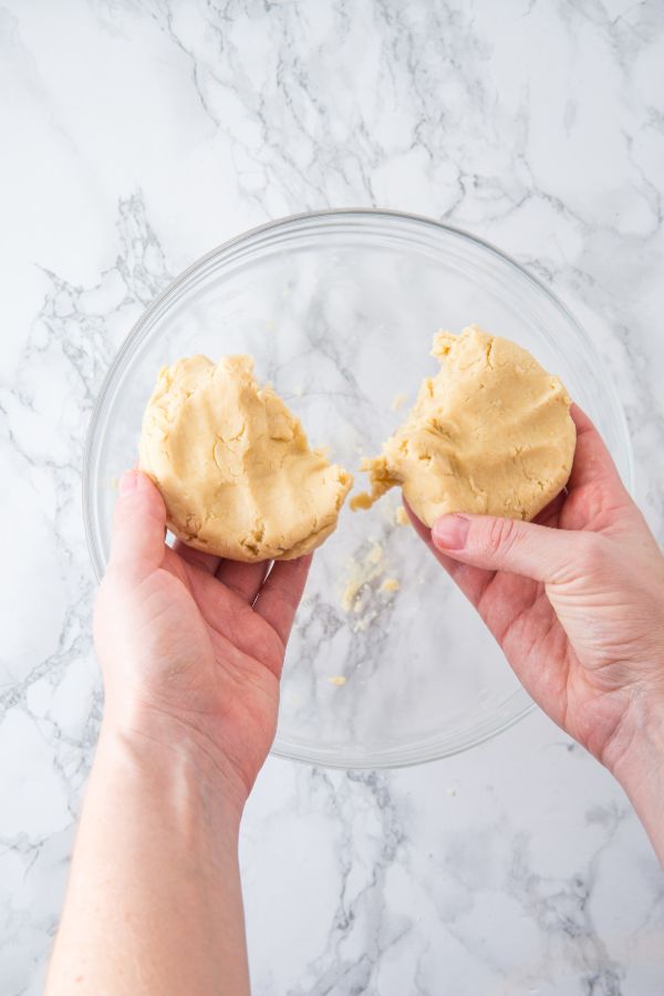 soft cookie dough split into two pieces.