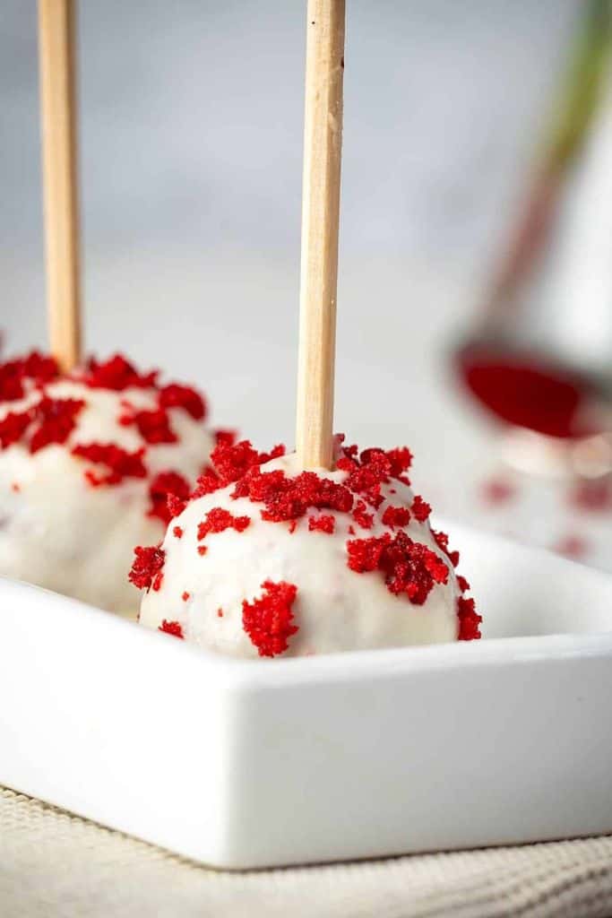 white chocolate red velvet cake pops on sticks.