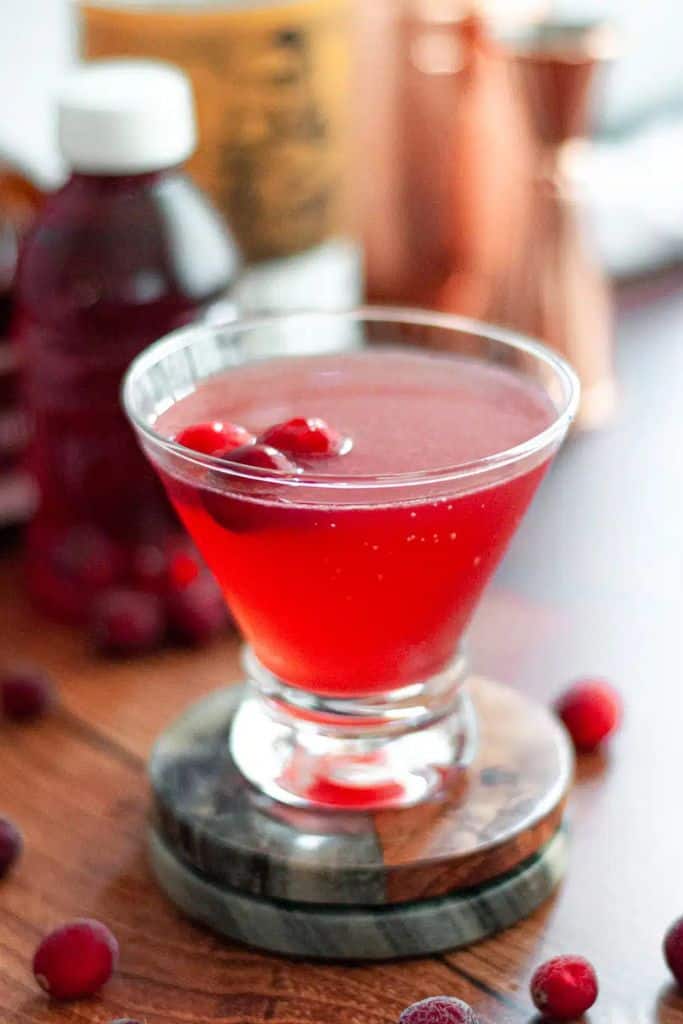 cranberry cosmopolitan cocktail in short glass.