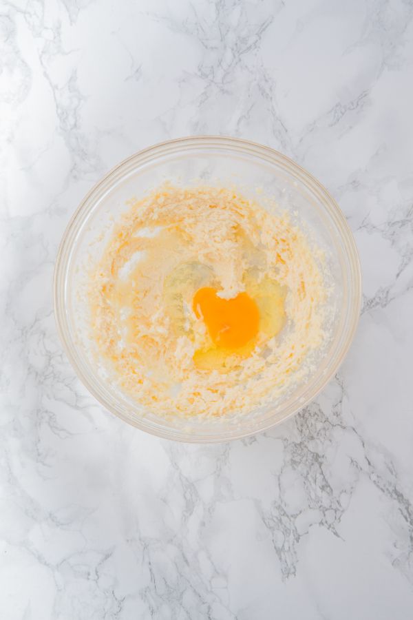 egg in cookie dough mixture in bowl.