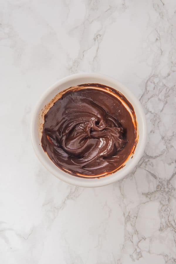melted chocolate for decorating cookies in bowl.