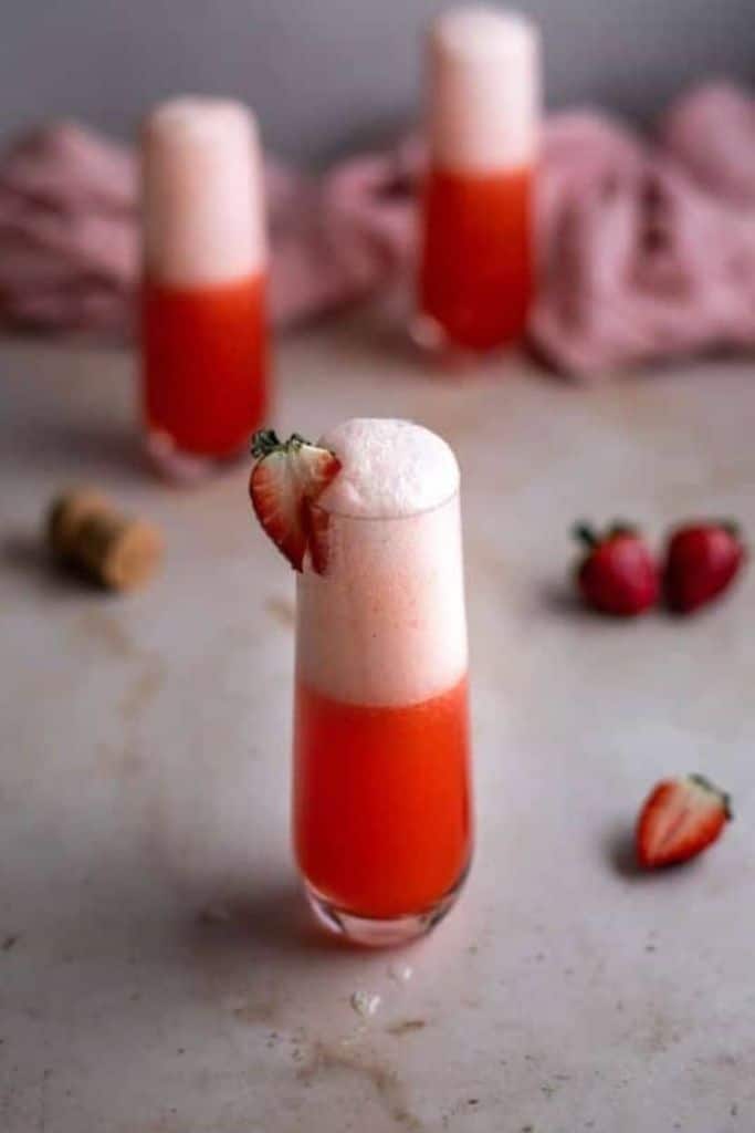 pink rossini cocktail in champagne glass.