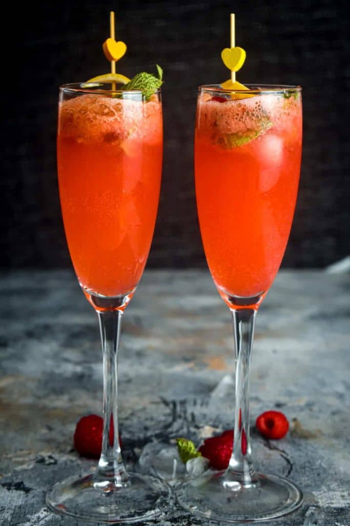 2 raspberry twist cocktails in champagne glasses.