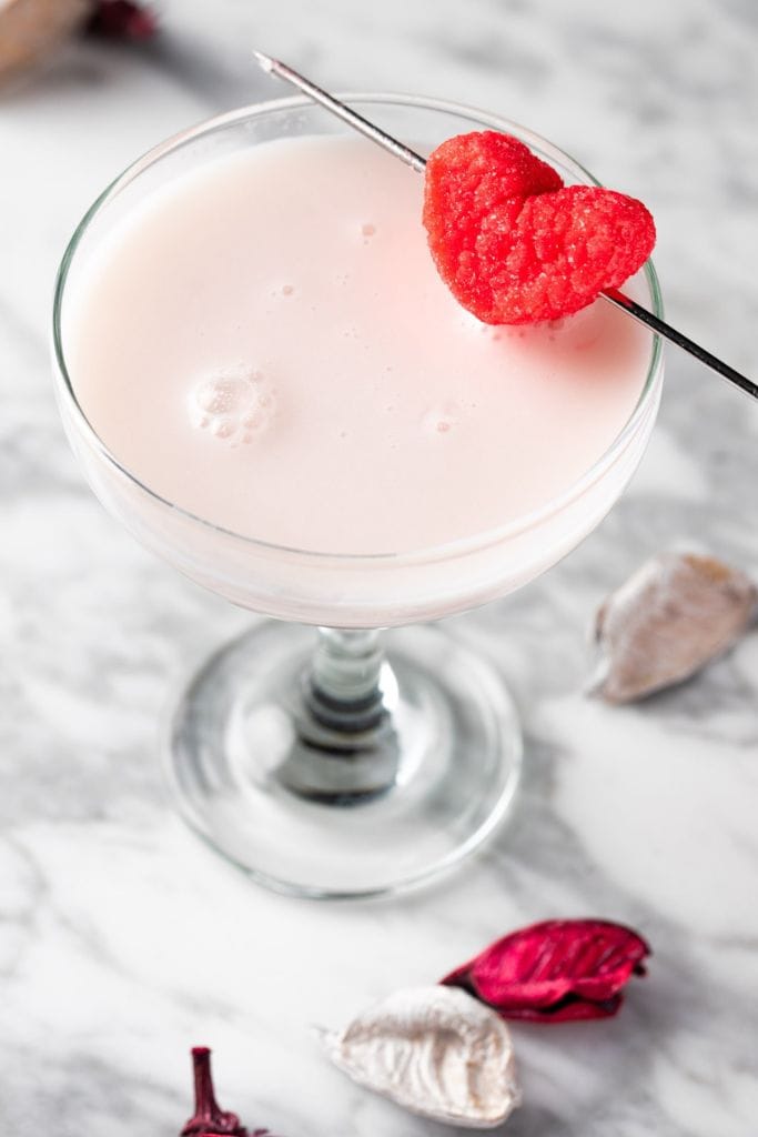 raspberry white chocolate martini with garnish.